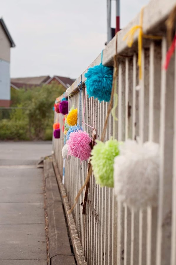 Pompoms hung on the railings on the canal bridge in Selby